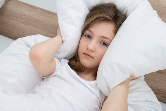 Girl Covering Ears With Pillow