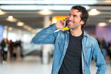 Handsome man talking to mobile over white background