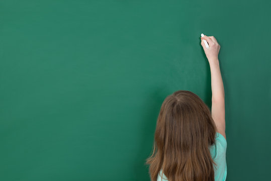 Girl Writing On Chalkboard