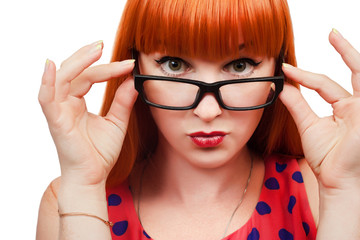 Pin-up 50's style red-haired girl in glasses on white background