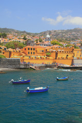 Ancient fortress, city beach and fishing boats. Funchal, Madeira, Portugal