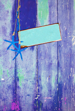 Blue colorful vintage background with shabby distressed grungy texture hippie style, blue starfish and turquoise metal plate for text message.