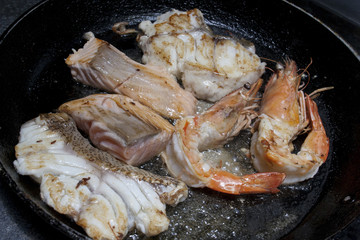 fried seafood tuna dorado fish in a frying pan