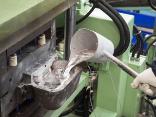 operator pouring aluminum automotive parts