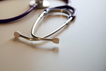 Fototapeta premium Stethoscope in sun on the desk, close up