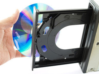 below of hand inserting CD or Dvd put into opened tray isolated on white