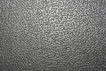 The texture of black rough plastic. Black pimply plastic background.The plastic is black with convex patterns.