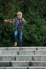 little boy jumping on the stairs