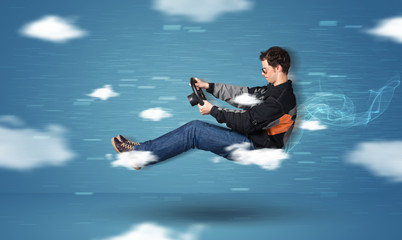 Funny racedriver young man driving between clouds concept