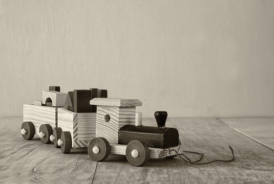 Wooden toy train over wooden floor. selective focus. black,white
