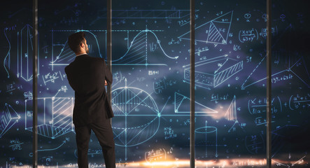 Businessman drawing business graphs