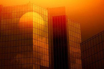 Office building reflection sunrise.
Office building at sunrise reflected in a window.
