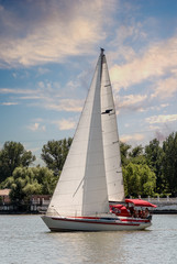 People ride on a yacht under sail