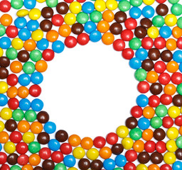 Frame of colorful candy on a white background with space for you