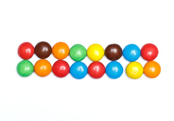 symbol sign dash minus   plus of colorful candy on a white backg