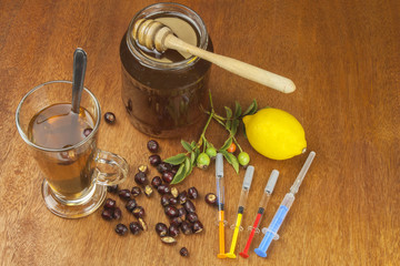 Rosehip tea and flu vaccination. Traditional medicine and modern treatment methods. Injection of influenza vaccine. Household treatment of flu and colds.
