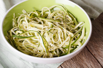 Natural food: raw zucchini pasta in a bowl closeup. horizontal
