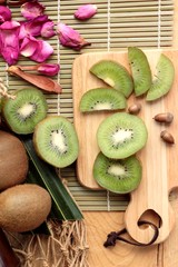 Kiwi fruit juicy green on wood background.
