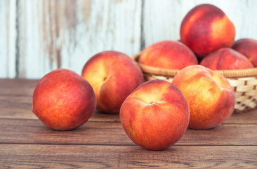Fototapeta na wymiar Closeup of peach fruits on wooden table