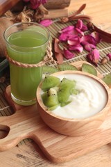 Yogurt white with green kiwi fruit and kiwi juice.