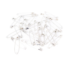 Fototapeta premium Surface covered with multiple safety pins isolated on white