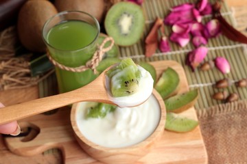 Yogurt white with green kiwi fruit and kiwi juice.