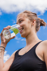 Teenage girl drinking a glass of water