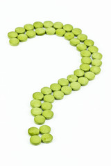 Green pills arranged in a shape of question mark symbol