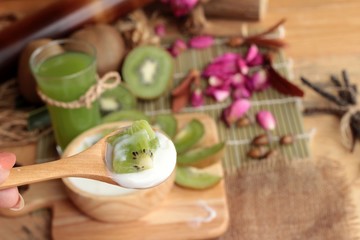 Yogurt white with green kiwi fruit and kiwi juice.