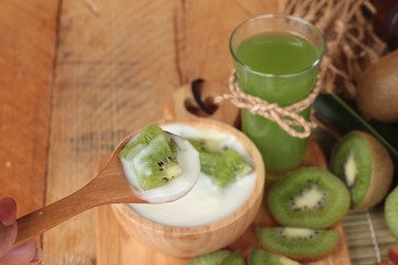 Yogurt white with green kiwi fruit and kiwi juice.