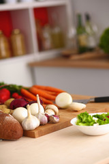 Young woman cutting vegetables in the kitchen