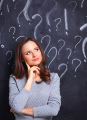 Young girl with question mark on a gray background