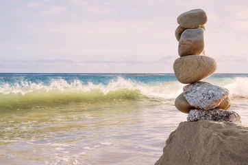 Crédence de cuisine en verre imprimé Eau A seascape featuring a column of balanced rocks and a breaking wave overlooking the Pacific ocean at sunset.  
