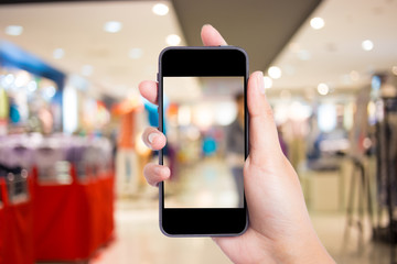 Taking a picture with a smart phone in shopping mall.