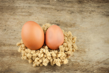 fresh brown eggs on wood background