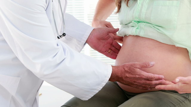 Pregnant woman being checked by a doctor