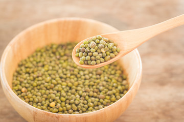 Raw green bean in wooden bowl