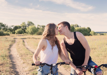 young couple having a bike ride in nature