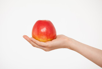 Female hand holding a red apple