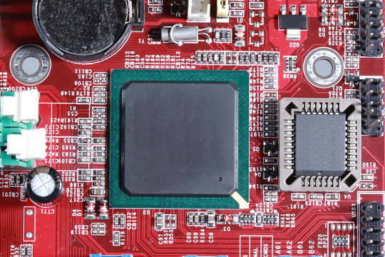 Close-up of red electronic circuit board with processor