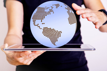 Woman holding tablet PC with globe