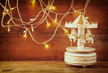 image of old vintage white carousel horses with garland