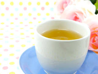 tea in cup on sweet polka dot background