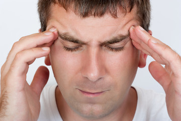 Fototapeta premium Portrait of a man with a headache close up