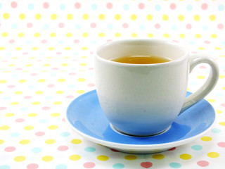tea in cup on sweet polka dot background
