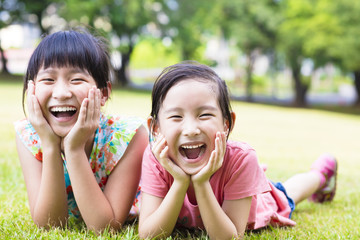 Fototapeta premium closeup happy little girls on the grass