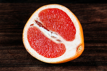 Fresh juicy Grapefruit slice. on wooden board. Rich witch vitamin C.