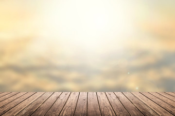 Naklejka na ściany i meble wooden floor with sunset sky blurred background