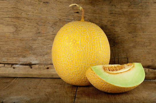 Yellow cantaloupe melon on the wooden background