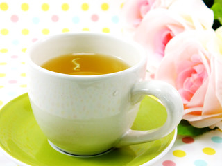 tea in cup on sweet polka dot background